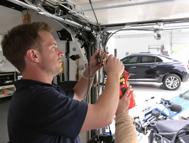 Stoneham Garage Door Repair safety certified technician performing cable replacement in Stoneham