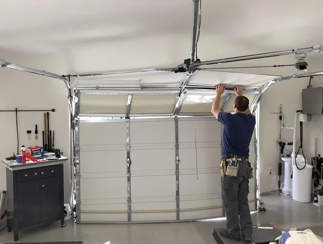 Stoneham Garage Door Repair specialist performing precise section replacement on Stoneham garage door